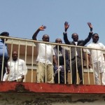 Fr. Eworo (in suit) acknowledging cheers from the crowd of supporters
